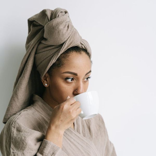A calendar and a cup of tea symbolizing a daily wellness routine.